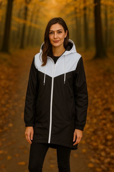 Zweifarbige Windjacke – sportlich, leicht und herbsttauglich. Frau trägt eine zweifarbige Windjacke in Schwarz und Weiss, kombiniert mit Jeans und Sneakers.