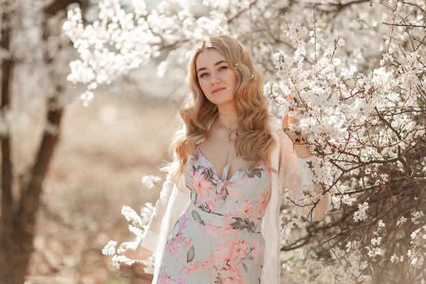 Frau im Blumenkleid mit weißen Blüten