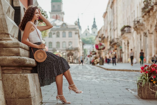 Junge Frau in Sommerkleidung in einer Innenstadt