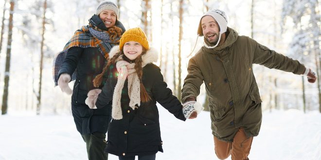 Familie im WInter, alle tragen Wintermantel