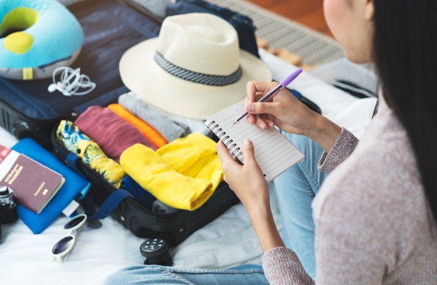 Junge-Frau-packt-Koffer - Wie viel Kleidung für 14 Tage Urlaub