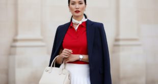Tenniscore Modetrend Stylingideen, Frau trägt weißen Tennisrock mit roten Poloshirt und dunkelblauem Blazer